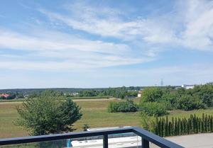a view of a field from a balcony at Kawalerka pod lasem in Poddębice
