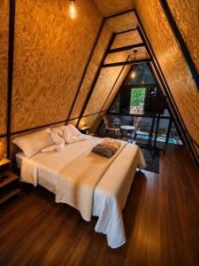 a bedroom with a large bed in a attic at Chalé Boa Vista in Duque de Caxias