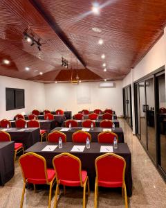 a conference room with tables and red chairs at Junto Al Mar - Mini suite in San-Pédro