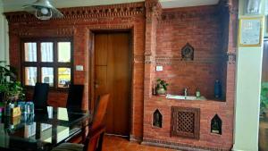 a brick wall with a fireplace in a restaurant at Du Nepal Inn in Kathmandu