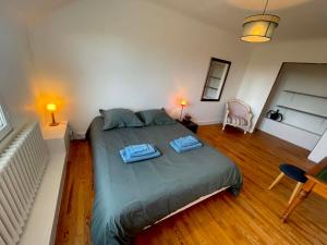 a bedroom with a bed with two towels on it at Le Bercail in Plouézec
