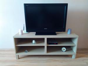 a tv sitting on a white entertainment center at Geri Apartment in Burgas City