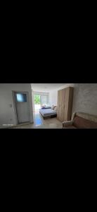 a living room with a bed and a window at Apartmani Seki in Bar