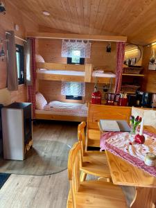 a room with a dining table and a room with bunk beds at Chalet Josef in Braunsbedra +11 photos