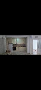 a kitchen with white cabinets and an open door at Apartmani Seki in Bar +4 photos