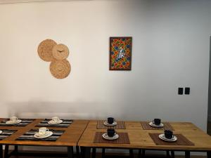 three wooden tables in a room with a picture on the wall at Fully equipped house - 7 guests in Petrolina