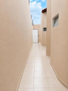 a hallway of a building with a white door at Fully equipped house - 7 guests in Petrolina