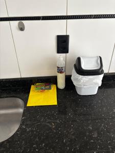 a bathroom counter with a sink and a bottle of cleaner at Fully equipped house - 7 guests in Petrolina +34 photos