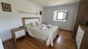 a bedroom with a bed and a wooden floor at Caserio EL AJO in Herrán +24 photos