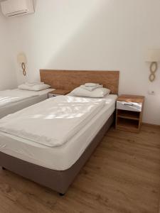 a bedroom with two beds and a wooden floor at Premium in Negotin