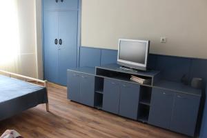 a bedroom with a blue cabinet with a tv on it at Saltywind House in Pomorie