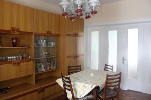 a dining room with a table and chairs and a chandelier at Saltywind House in Pomorie