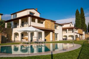 a villa with a swimming pool in front of a house at Entire house for couple with exclusive pool in Monsanto