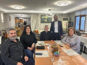 a group of people sitting around a table at Naila Hotel in Istanbul