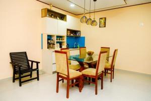 a kitchen with a dining room table and chairs at Midtown Mansion in Veyangoda