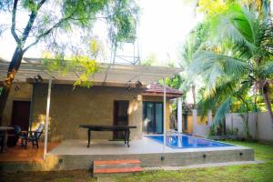 a ping pong table in front of a house at Midtown Mansion in Veyangoda
