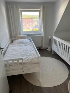 a bedroom with a white bed and a window at Auszeit in Melsungen