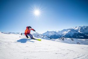 a person is skiing down a snow covered mountain at Ferienwohnung Rosenlaui in Meiringen