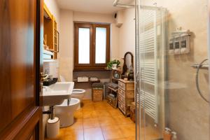 a bathroom with a toilet and a sink and a shower at I Monelli in Sestola +18 photos