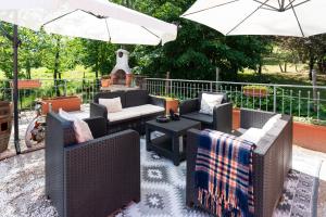 a patio with several chairs and an umbrella at I Monelli in Sestola