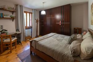 a bedroom with a bed and a desk in it at I Monelli in Sestola