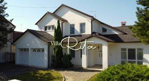 a white house with a garage at Villa Rita in Županja +5 photos