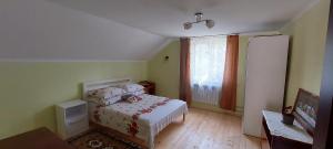 a small bedroom with a bed and a window at Вікенд WeekEnd in Kvasy +4 photos