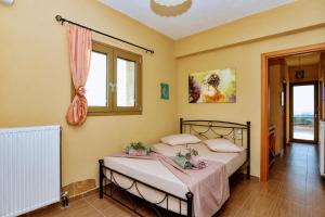 a bedroom with two beds and a window at Casa Adam and spa in Zakynthos +31 photos