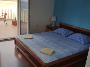 a bedroom with a bed with two towels on it at Buljarica Bay Apartments in Petrovac na Moru