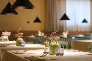 a set of tables with vases of flowers on them at Haus Meeresstern in Wangerooge