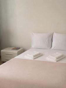 a white bed with two white towels on top of it at Monaco Studio "907" in Monte Carlo