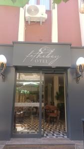 an entrance to a restaurant with a sign that reads offer at Fethibey Otel in Bartın