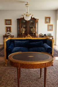 a living room with a blue couch and a table at Vila Foz Club - Algarve in Alvor