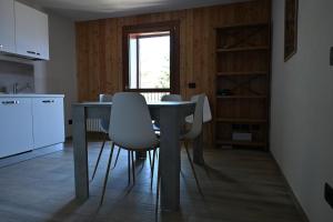 a kitchen with a table and chairs in a room at Chalet du Sky PILA in Cerise