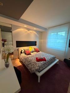 a bedroom with a bed with two red shoes on it at Casa CLEO in Domodossola