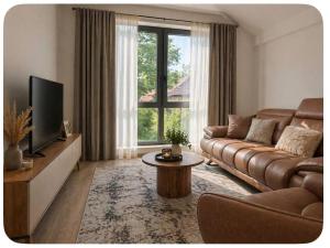 a living room with a couch and a tv at Luxury aprtmans in Mavrovo