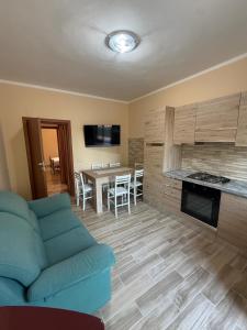 a living room with a blue couch and a table at Vale house in Monte San Biagio
