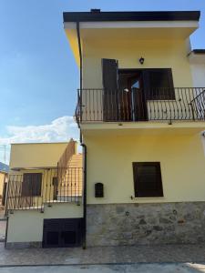 a building with two balconies on the side of it at Vale house in Monte San Biagio