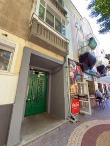 a green door on the side of a building at Storm in Varna City