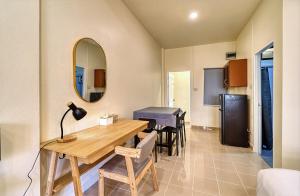 a kitchen and dining room with a table and a mirror at The Bulin Residence in Lamai