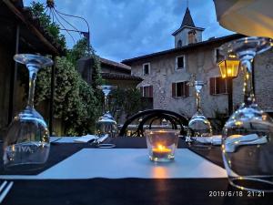 a table with wine glasses and a candle on it at La Locanda del Viandante in Mendrisio