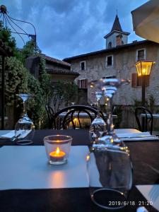 a table with a candle on a table with a building at La Locanda del Viandante in Mendrisio +12 photos