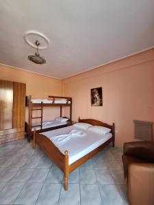 a bedroom with two bunk beds and a couch at Hotel Rossi in Vlorë +19 photos
