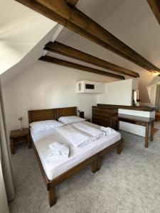 a bedroom with a bed and a piano at Penzión SIMI in Tatranská Lomnica