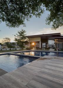 a swimming pool in front of a building at Modern Japandi Studio with Pool Near Mactan Airport in Bankal