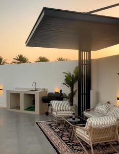 a living room with two couches and a table at Noya Chalet in Rumays