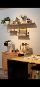 a kitchen with a table and a counter with shelves at Noya Chalet in Rumays