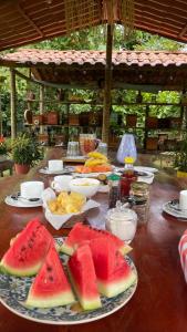 a table with slices of watermelon on a plate at Vale das Rainhas Pousada Santo Amaro BA in Santo Amaro