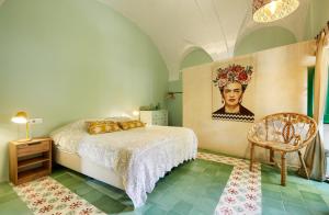 a bedroom with a bed and a painting on the wall at Mas Ferrer by 123ole in Sant Andreu del Terri