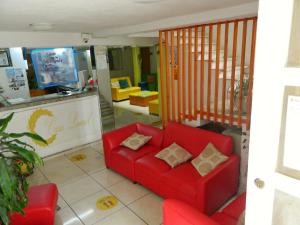 a red couch with pillows in a room at Casa Laurel in Cancún